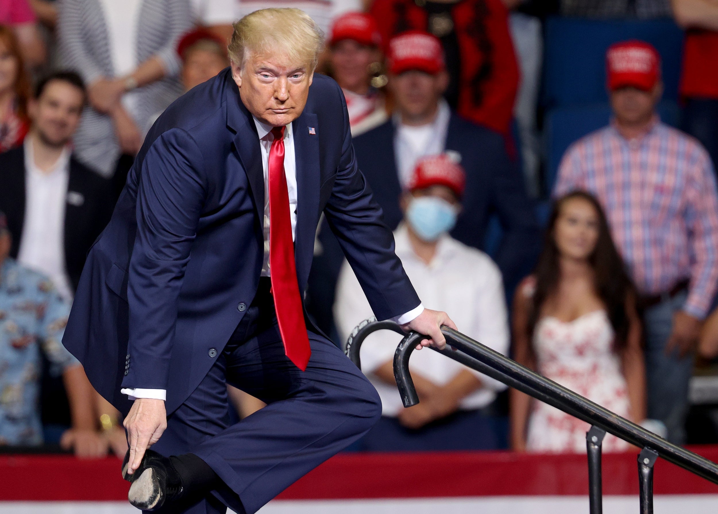 Donald Trump points to his shoe at a rally in Tulsa, Oklahoma during a lengthy explanation of why he walked so carefully on a ramp at West Point military academy a week earlier