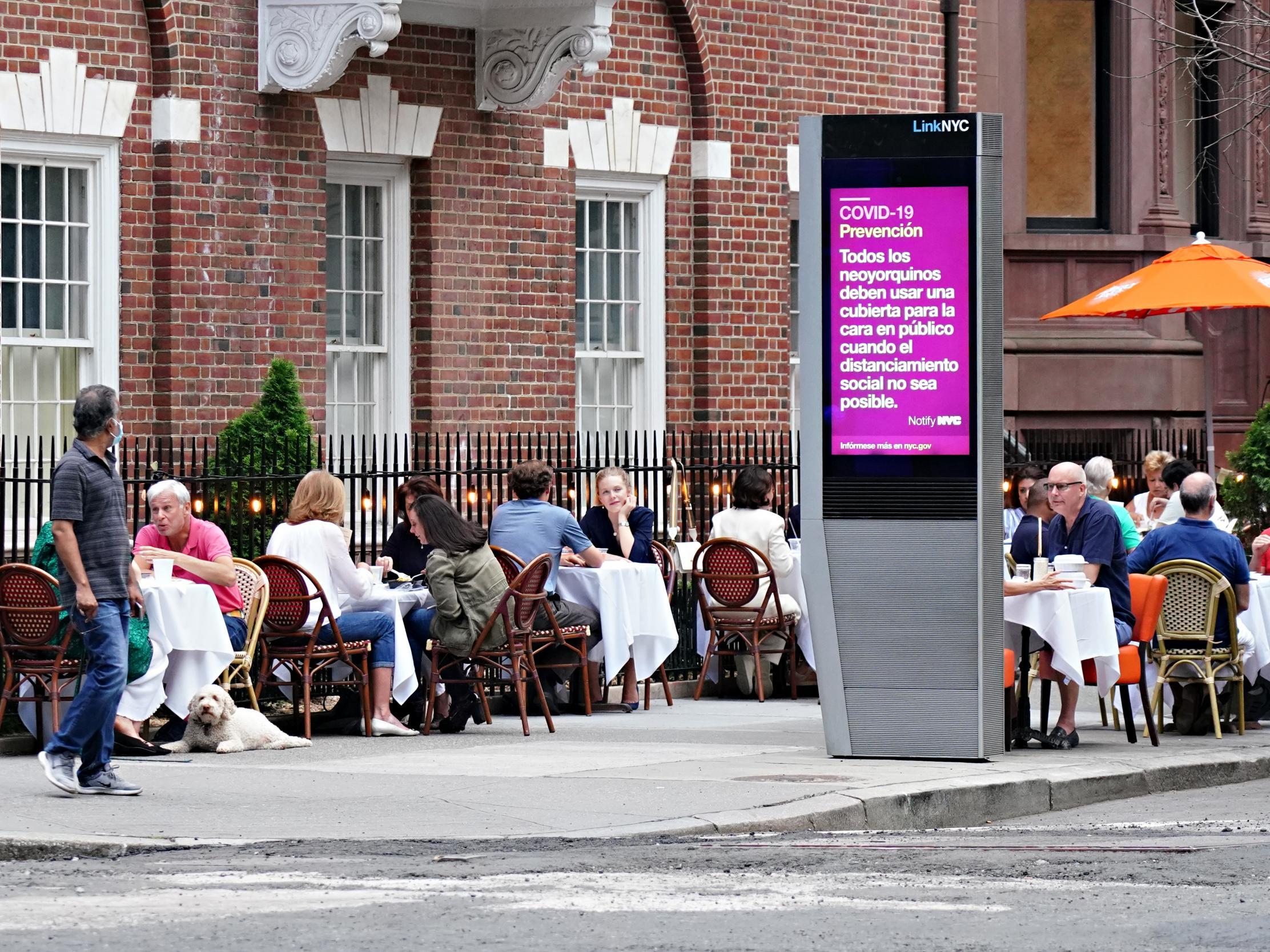 A restaurant on Madison Avenue serves drinks to customers seated at sidewalk tables as the city moves into phase two re-opening from the coronavirus pandemic