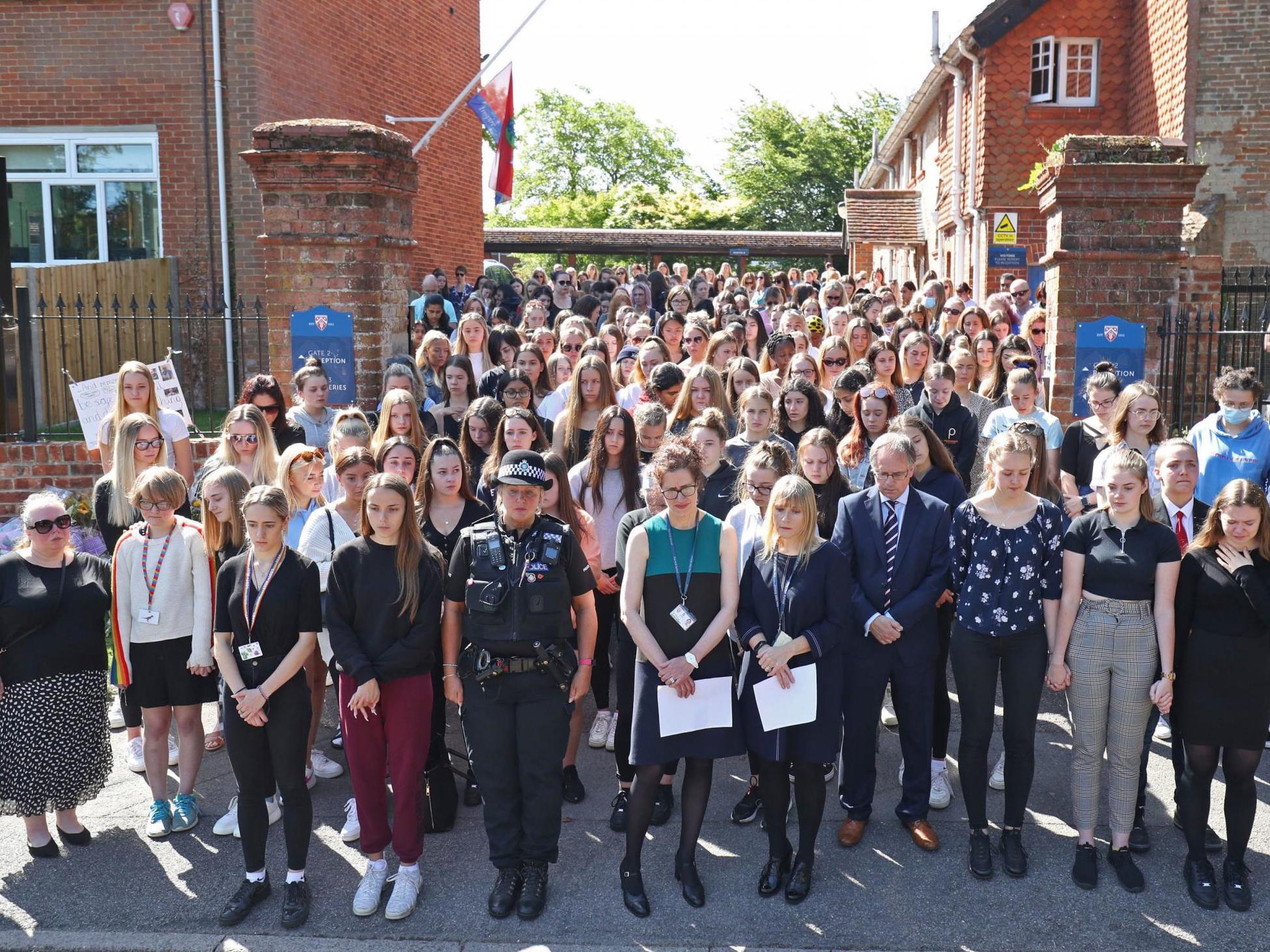 Colleagues and pupils of teacher James Furlong take part in a period of silence at the Holt School, Wokingham, Berkshire, on 22 June, 2020.