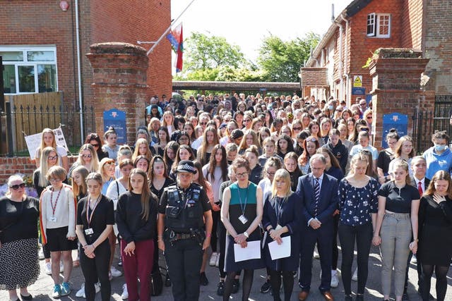 Colleagues and pupils of teacher James Furlong take part in a period of silence at the Holt School, Wokingham, Berkshire, on 22 June, 2020.