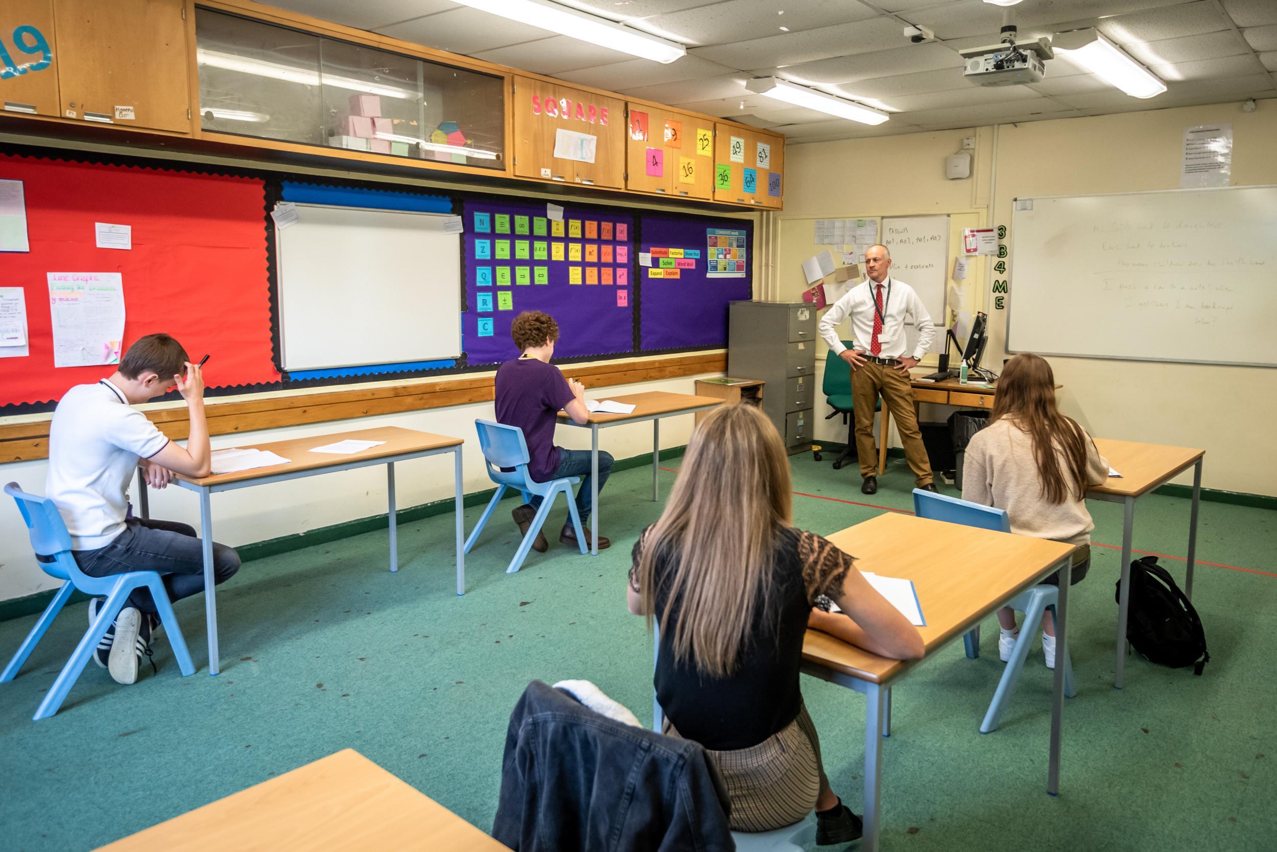 Hinchingbrooke head of sixth form teacher Charlie Fordham with Year 12 pupils in the new-look classroom