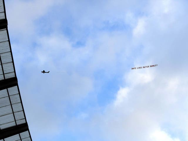 ‘White Lives Matter – Burnley’ banner is pictured flying over the Etihad (Gett