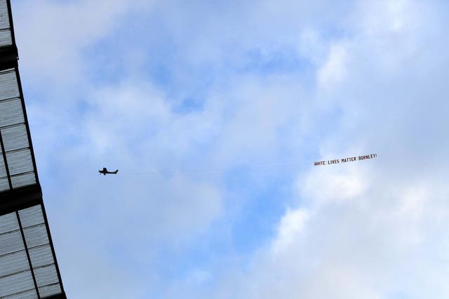 ‘White Lives Matter – Burnley’ banner is pictured flying over the Etihad (Gett