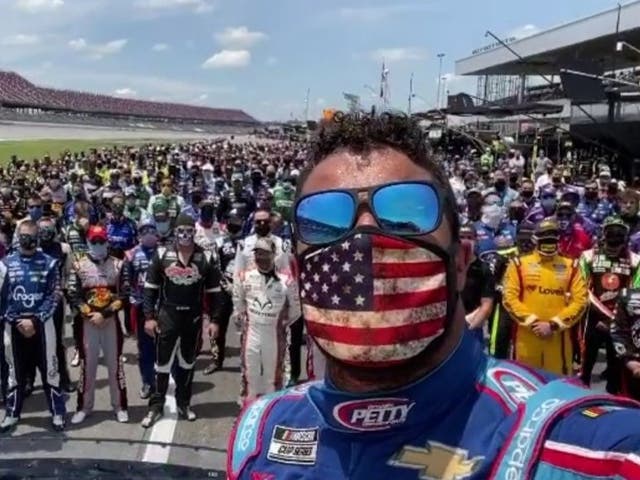 Nascar driver Bubba Wallace supported by drivers and members of pit crew