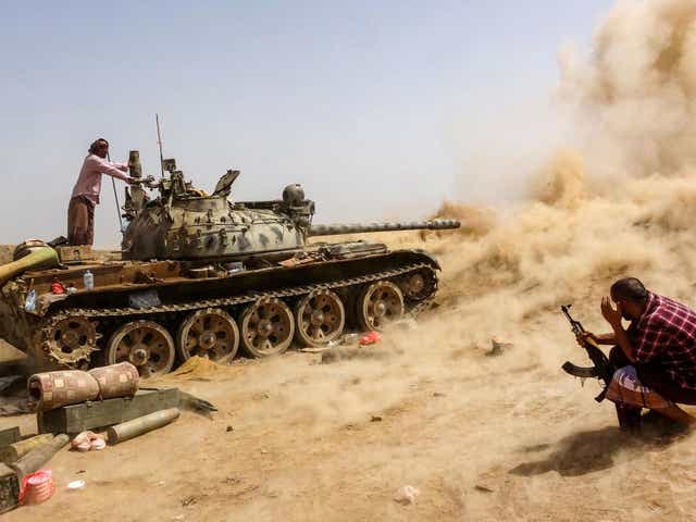 A tank belonging to forces loyal to Yemen's southern separatists fires while on the frontline of clashes with pro-government forces for control of Zinjibar, the capital of the southern Abyan province