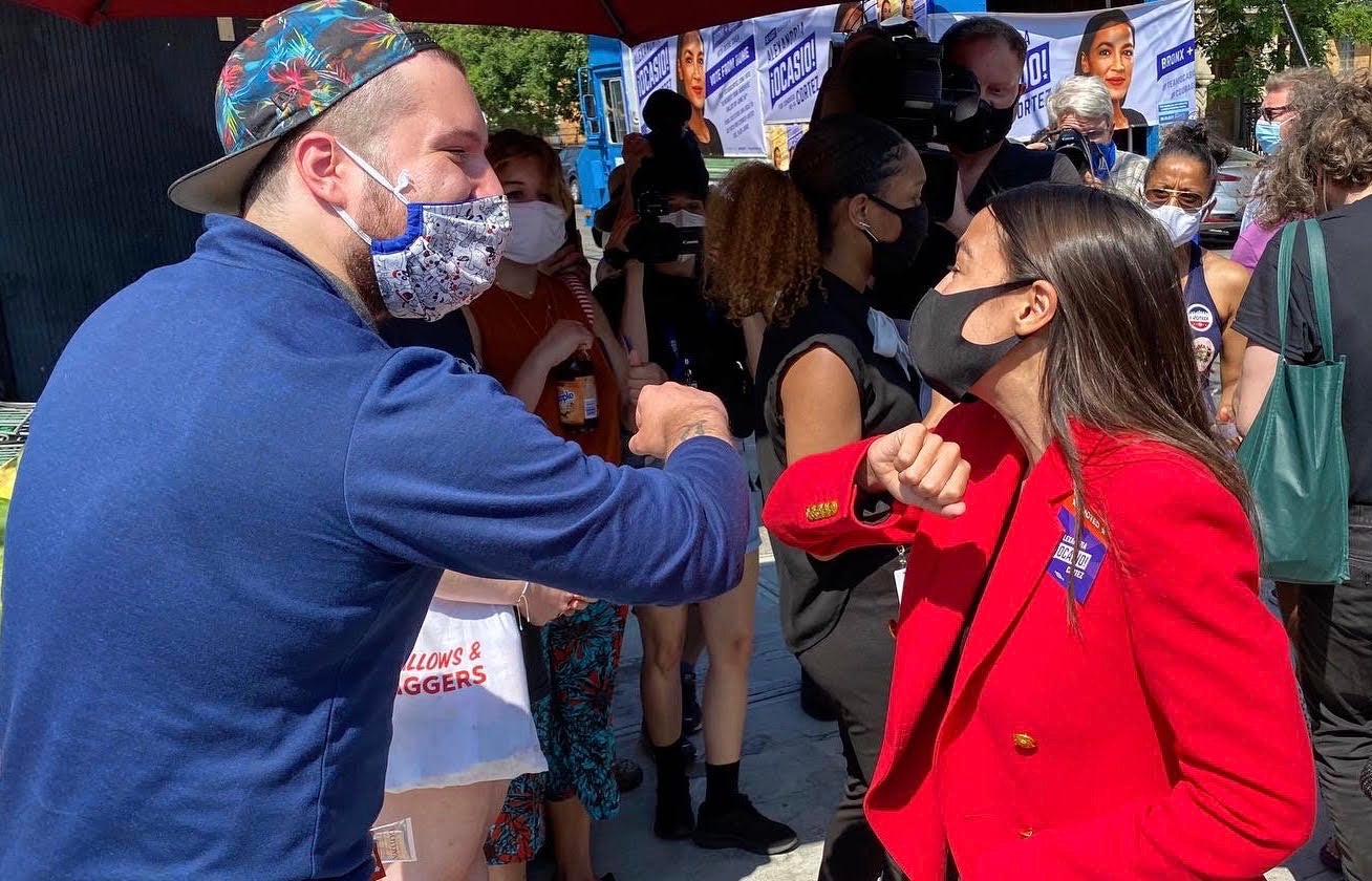 Alexandria Ocasio-Cortez greets voters in Astoria, Queens, on Tuesday (Richard Hall/The Independent)