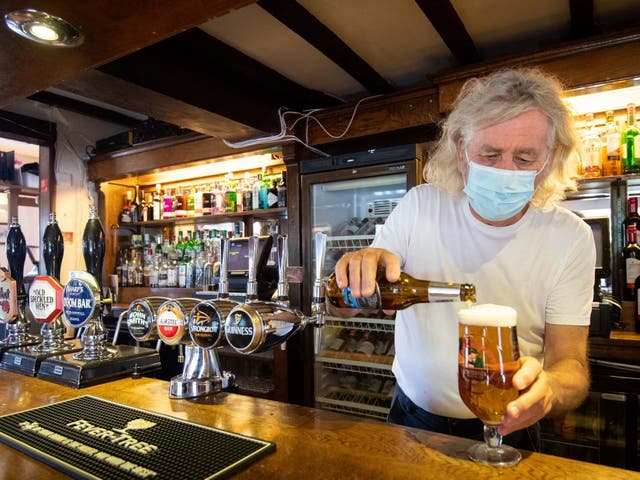 Phil Weaver, owner of The Old Smith in Church Lawford, Warwickshire, pours a drink as pub and hospitality bosses have cheered the government's proposals to allow customers through their doors again