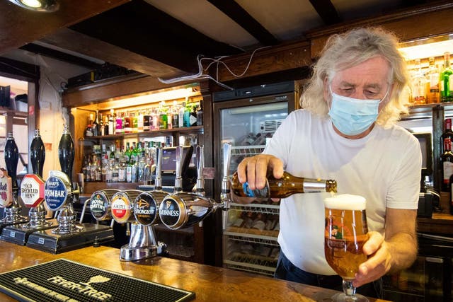 Phil Weaver, owner of The Old Smith in Church Lawford, Warwickshire, pours a drink as pub and hospitality bosses have cheered the government's proposals to allow customers through their doors again