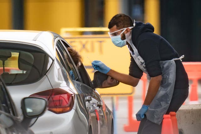 A person is tested at a drive through coronavirus testing site in Wembley. Britain's failure to rapidly boost its testing capacity has been criticised throughout the pandemic