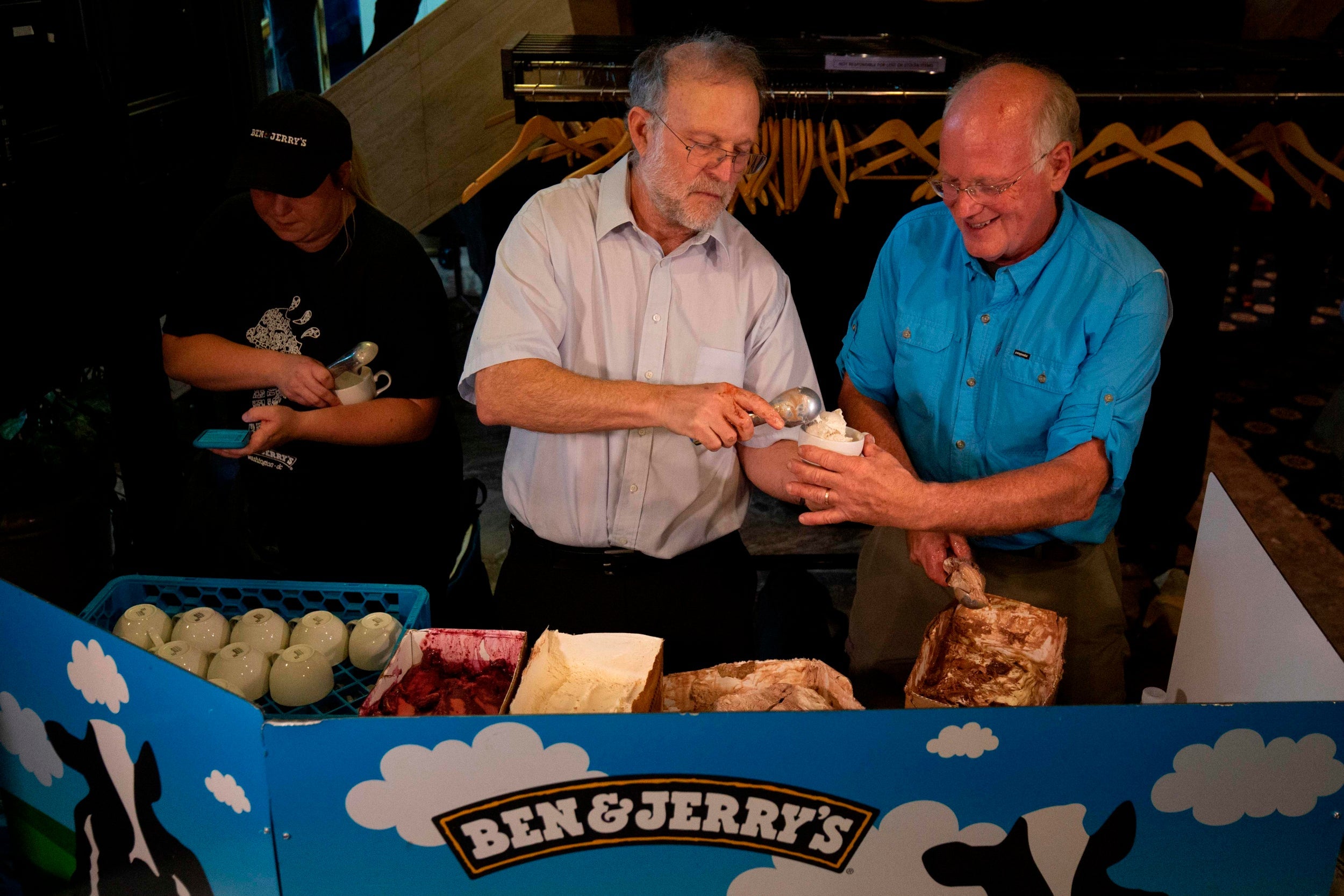 Ben and Jerry’s cofounders Ben Cohen (left)?and Jerry Greenfield serve Justice ReMix’d. a flavour?backing criminal justice reform, in 2019 (AFP)