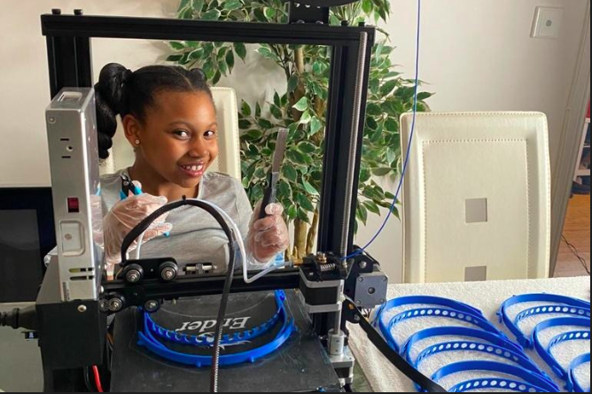 Nahla-Rose Bartlett-Vanderpuye, eight, using a 3D printer to make visors for NHS workers