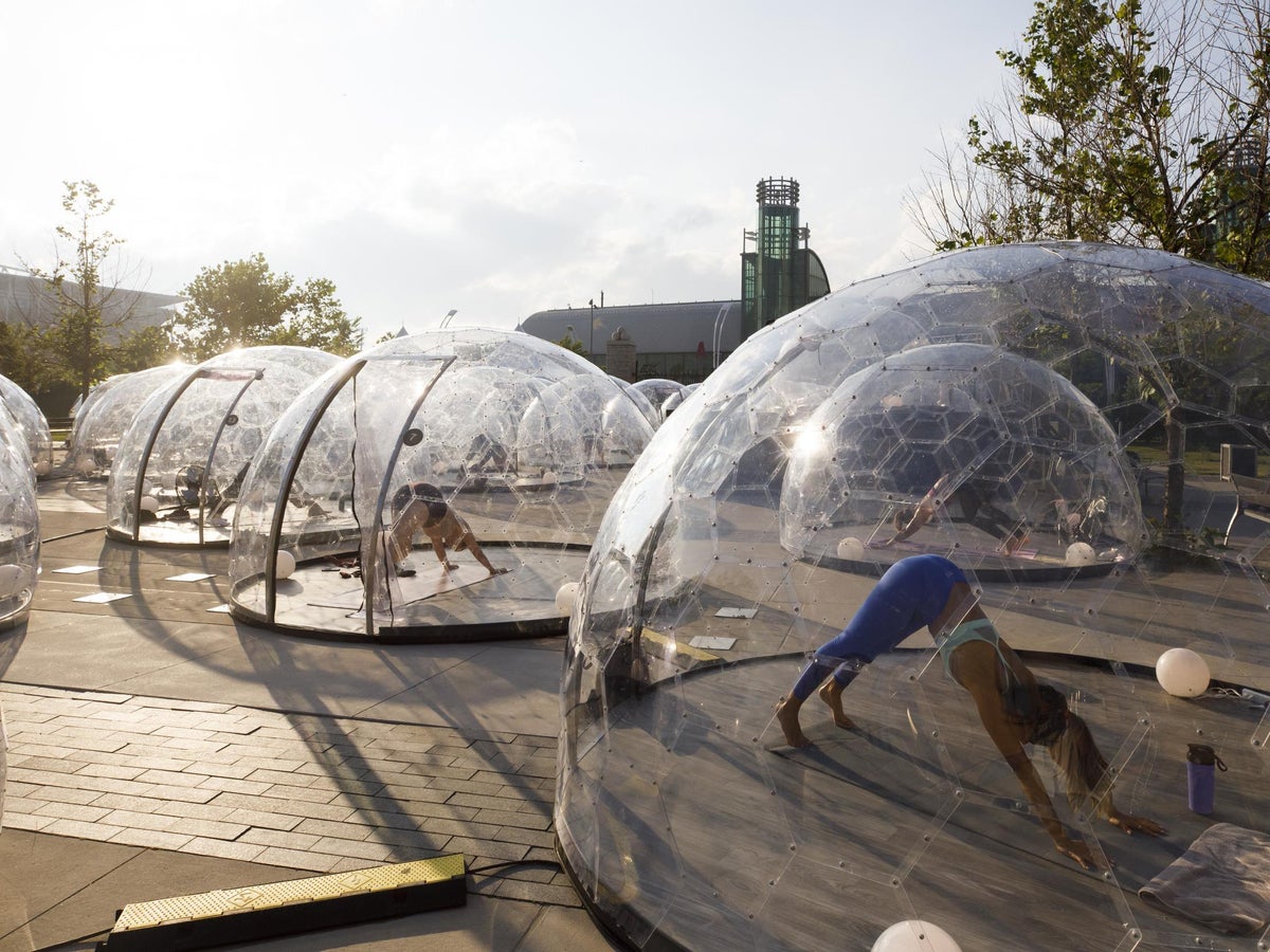 Yoga studio installs individual plastic bubbles so people can exercise in  large groups, The Independent