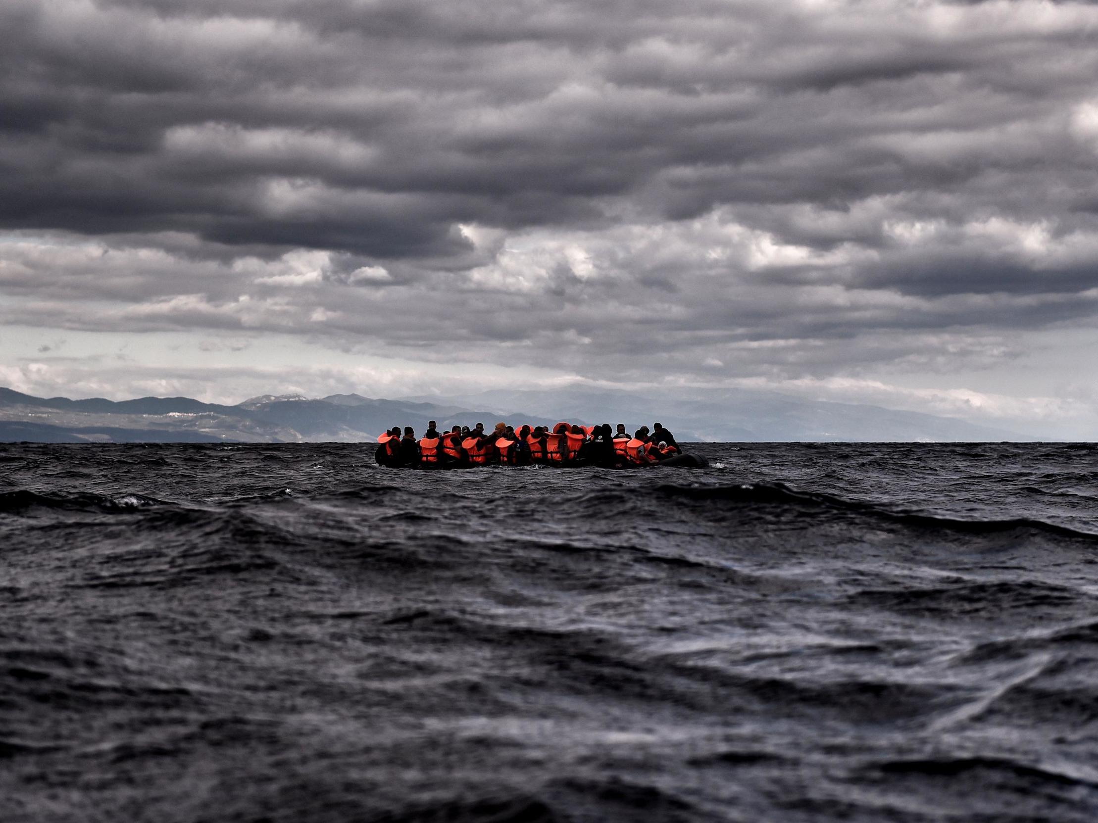 Refugees and migrants sail towards the Greek island of Lesbos on 25 October 2015 as they cross the Aegean sea from Turkey