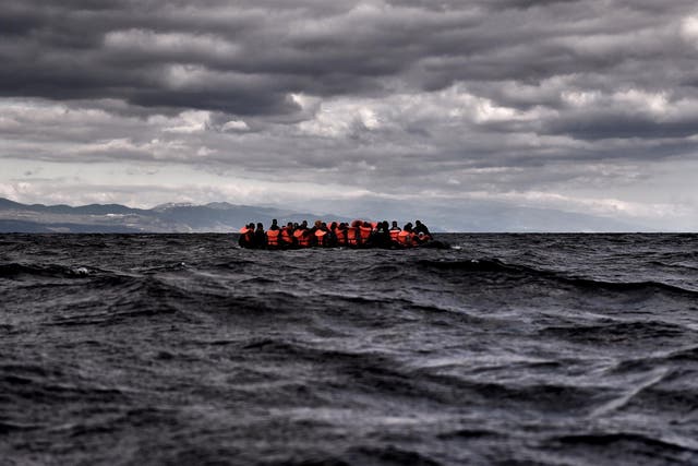 Refugees and migrants sail towards the Greek island of Lesbos on 25 October 2015 as they cross the Aegean sea from Turkey