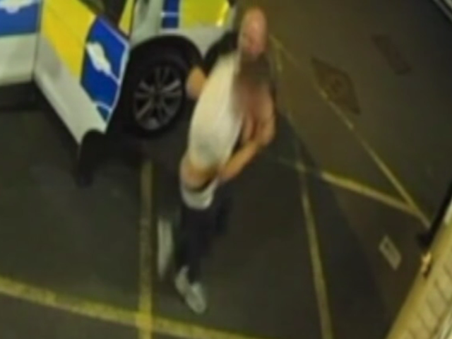CCTV of PC Reynolds pushing victim Jamie Cruse to the floor at Newtown police station in Powys, Wales.