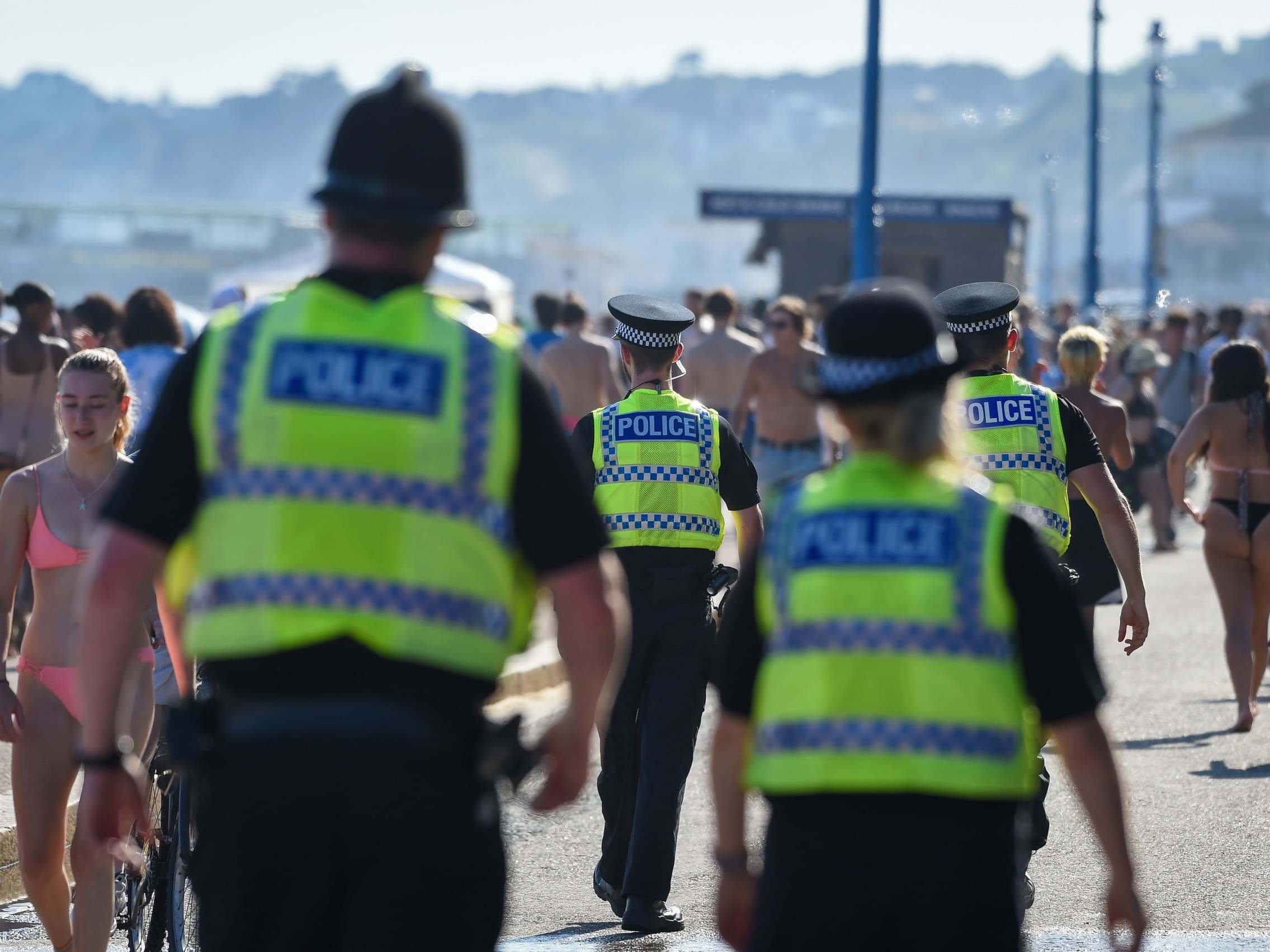 Police walk among sunseekers in Bournemouth yesterday
