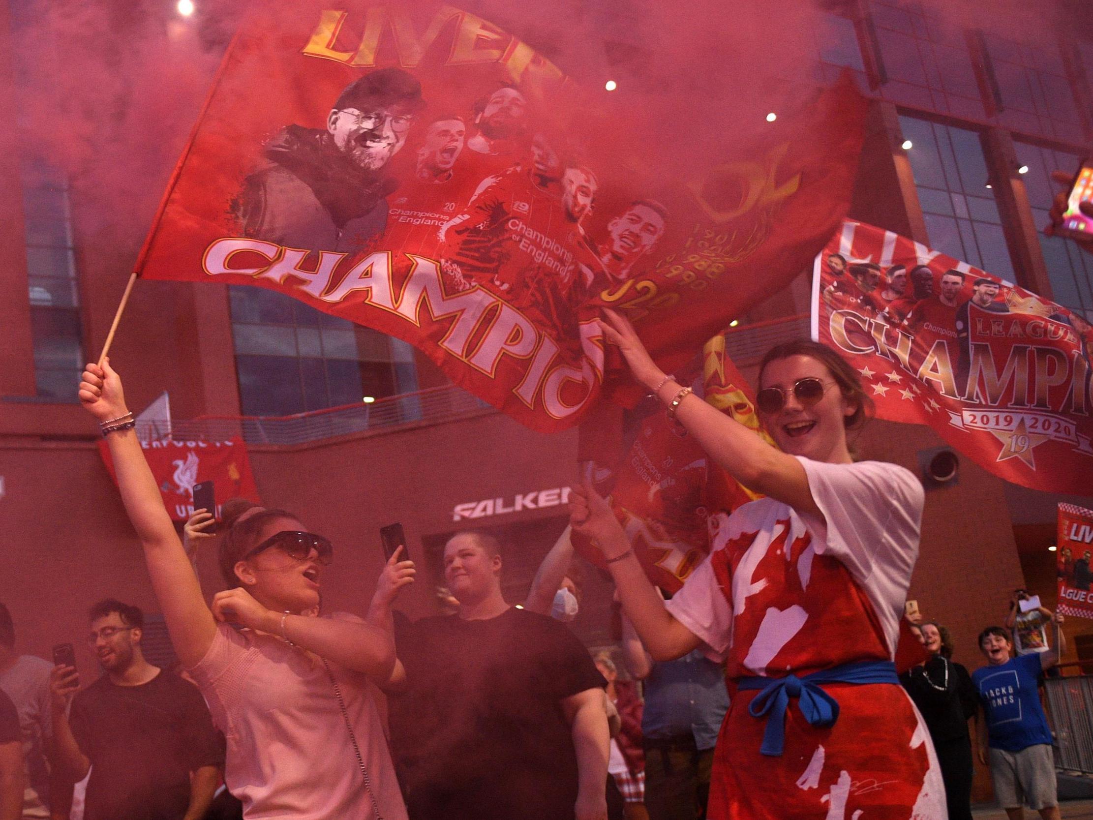 Fans at Anfield celebrate Liverpool winning the Premier League title (AFP via Getty Images)