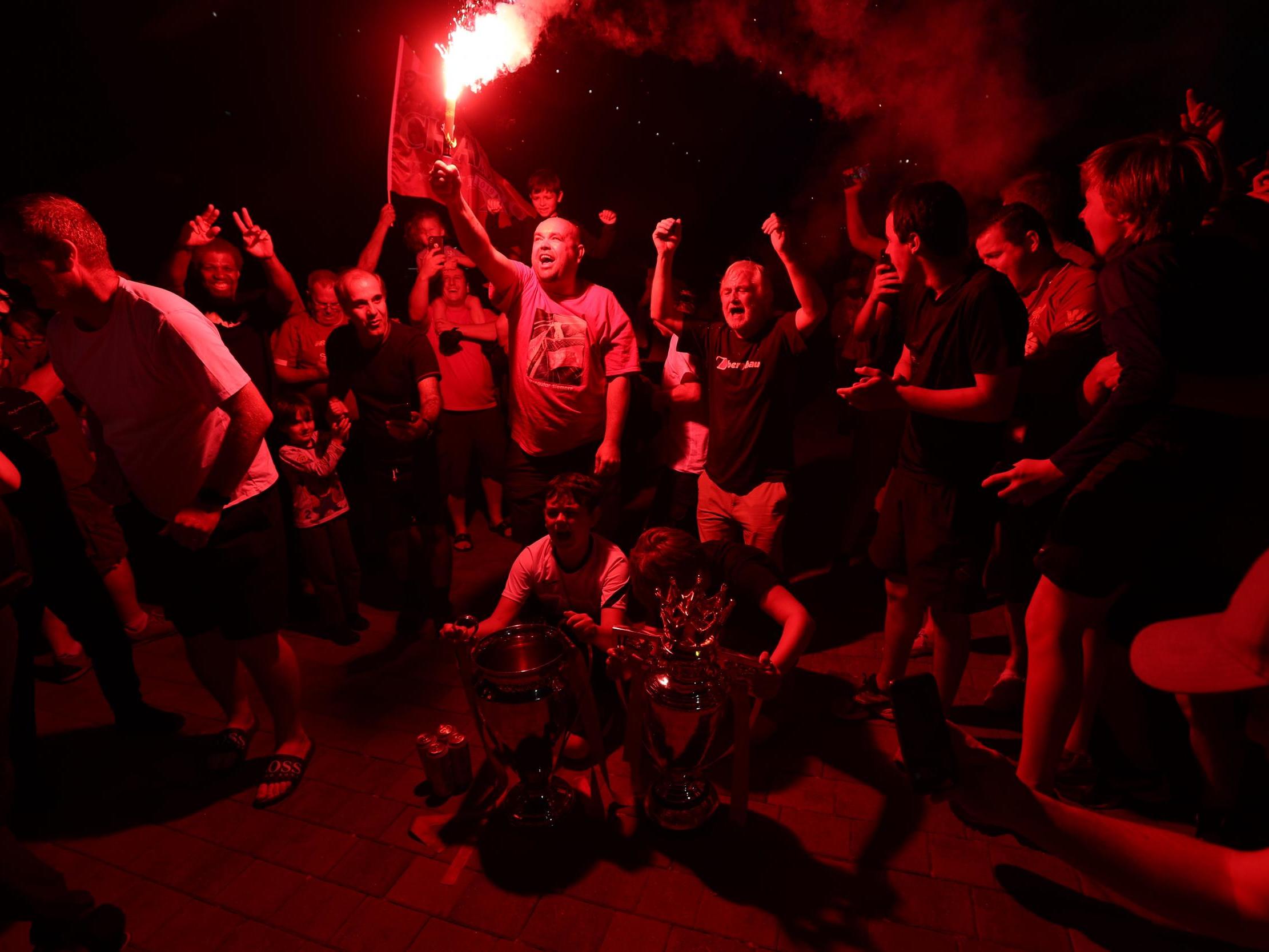 Fans at Anfield celebrate Liverpool winning the Premier League title