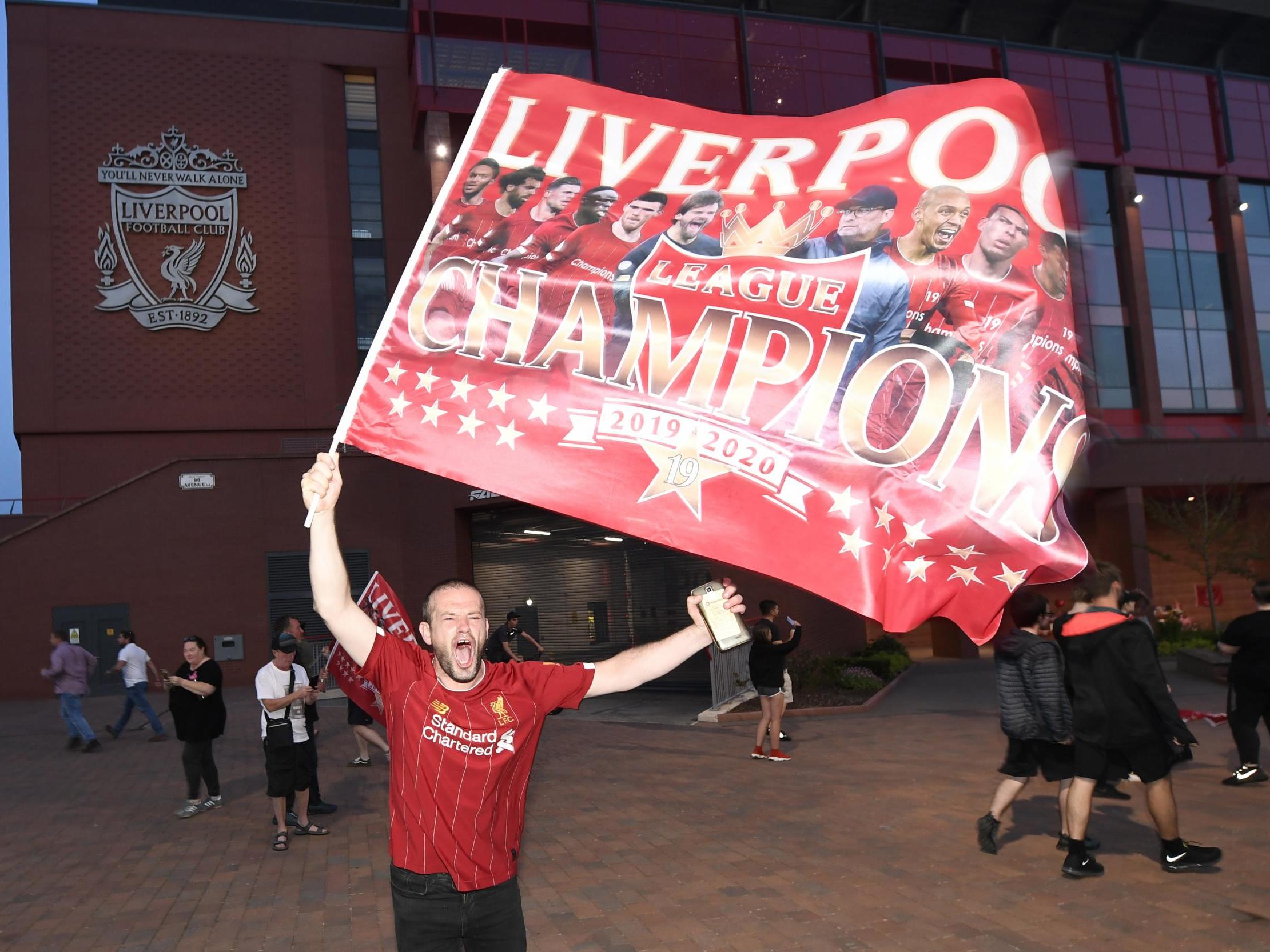 A Liverpool fan with a banner at Anfield