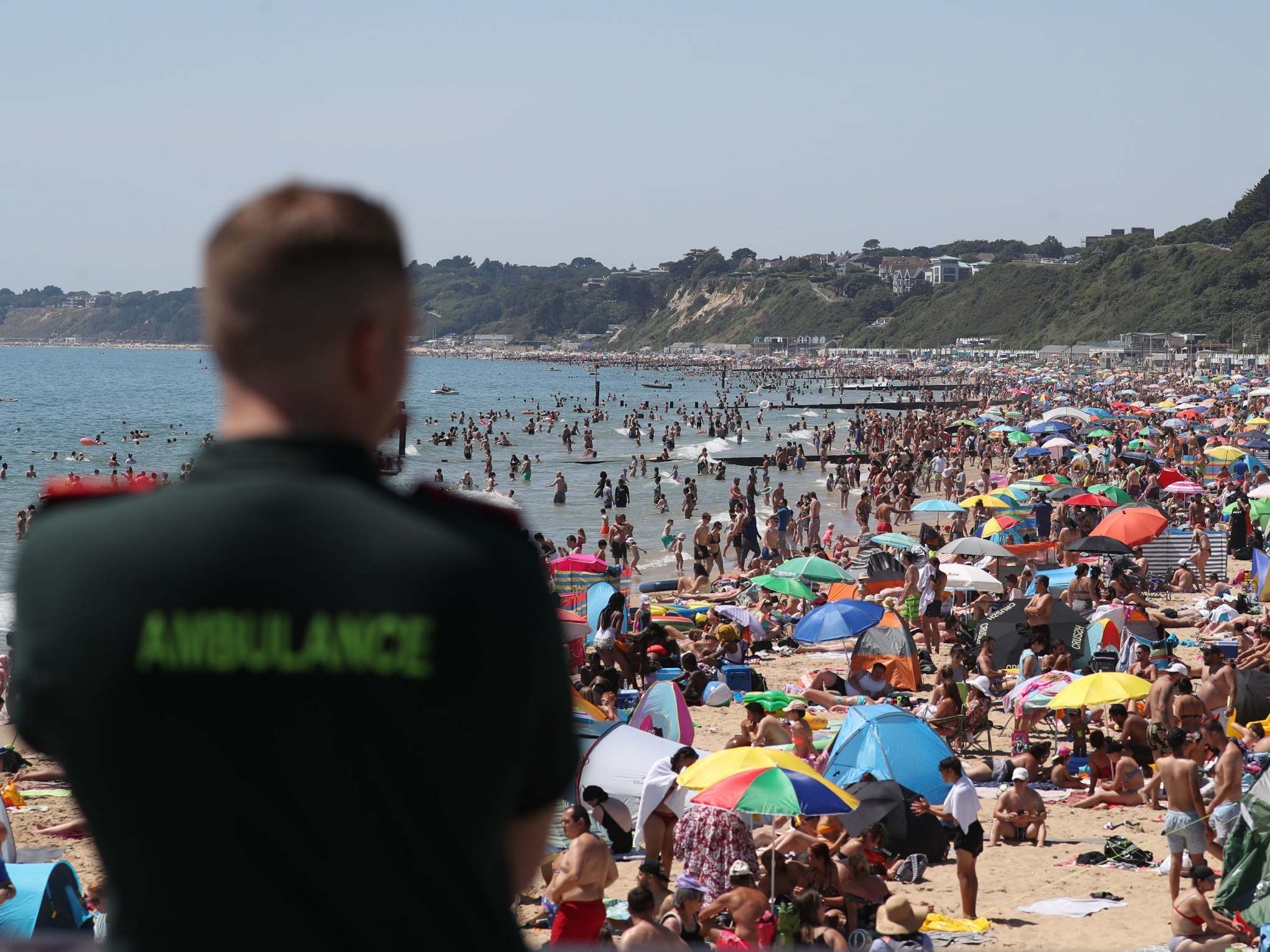 File photo of paramedic looking out on Bournemouth beach during a heatwave on 25 June 2020