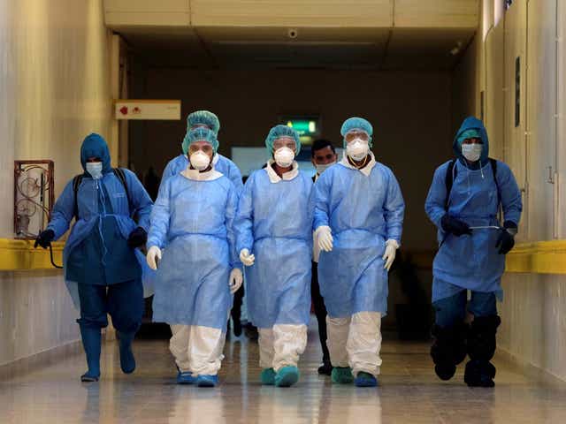 Employees from a disinfection company sanitise the corridors of Benghazi Medical Centre
