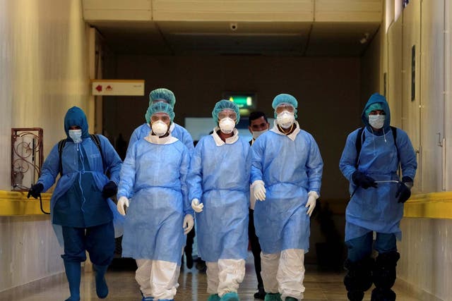 Employees from a disinfection company sanitise the corridors of Benghazi Medical Centre