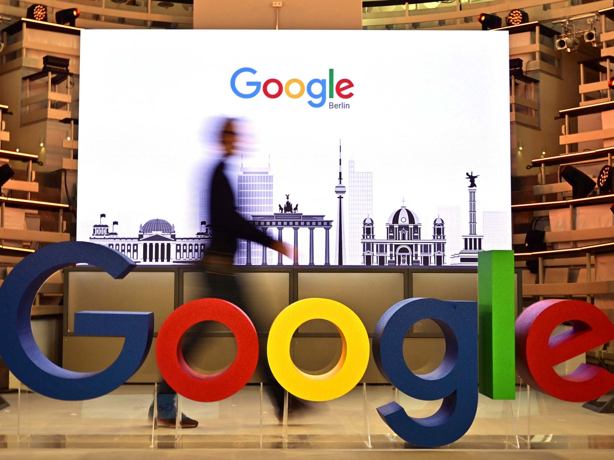 A technician passes by a logo of US internet search giant Google during the opening day of a new Berlin office of Google
