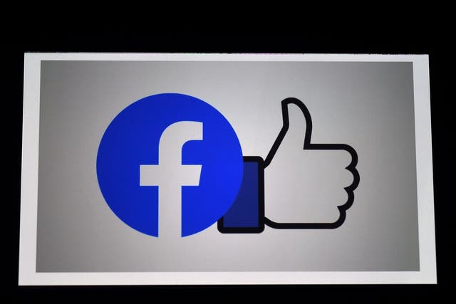 A Facebook App logo is displayed on a smartphone in Arlington, Virginia