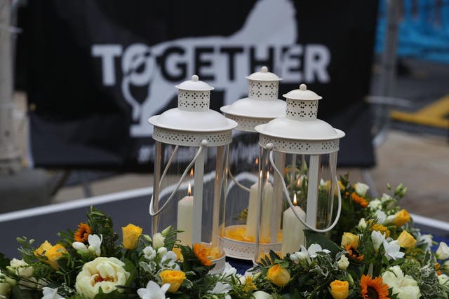 Candles and flowers during a vigil at Market Place, Reading, held in memory of David Wails, Joseph Ritchie-Bennett and James Furlong, who were killed in the Reading terror attack in Forbury Gardens in the town centre, shortly before 7pm on June 20