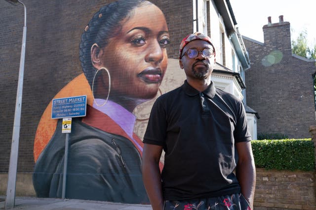 Visual artist Dreph with his mural painted on the side wall of the Beales' house – opposite The Queen Victoria pub – which will become a permanent backdrop to storylines in the BBC1 soap