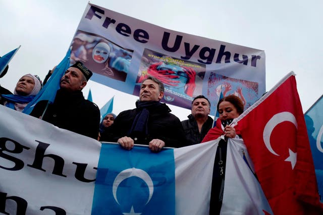 Demonstrators take part in a protest outside the Chinese embassy in Berlin to call attention to Chinas mistreatment of members of the Uyghur community in western China