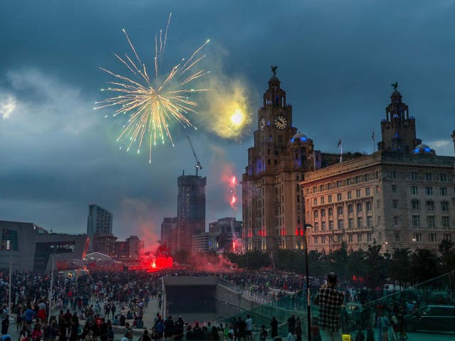 Fireworks go off outside the Liver Building in Liverpool as fans celebrate the Premier League title triumph