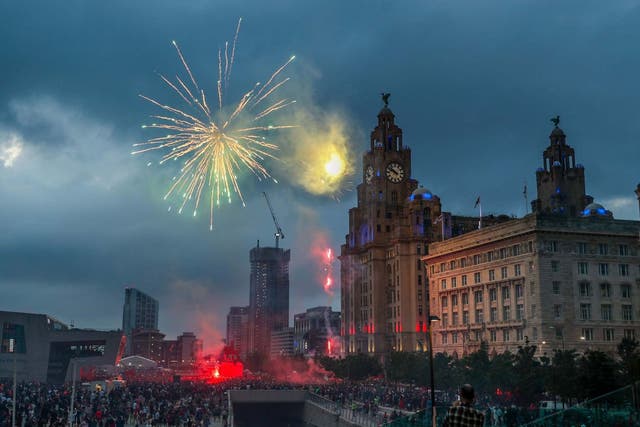 Fireworks go off outside the Liver Building in Liverpool as fans celebrate the Premier League title triumph