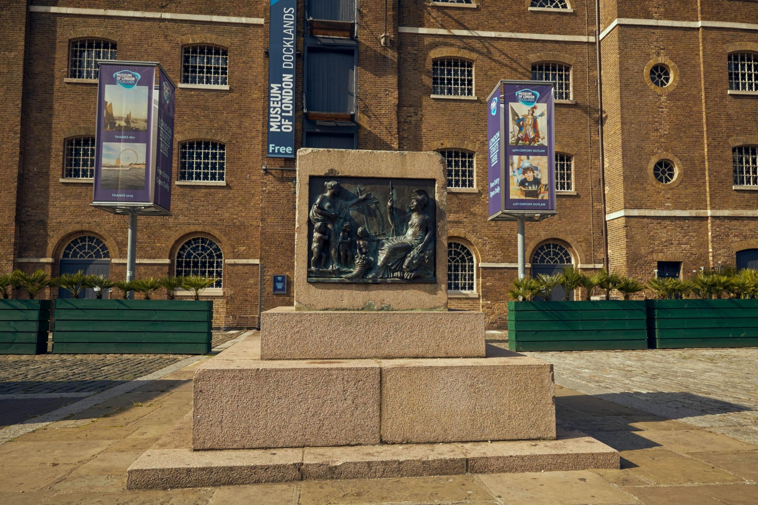 An empty plinth, where the statue of 18th-century slave owner Robert Milligan used to be, stands in front of the Museum of London Docklands