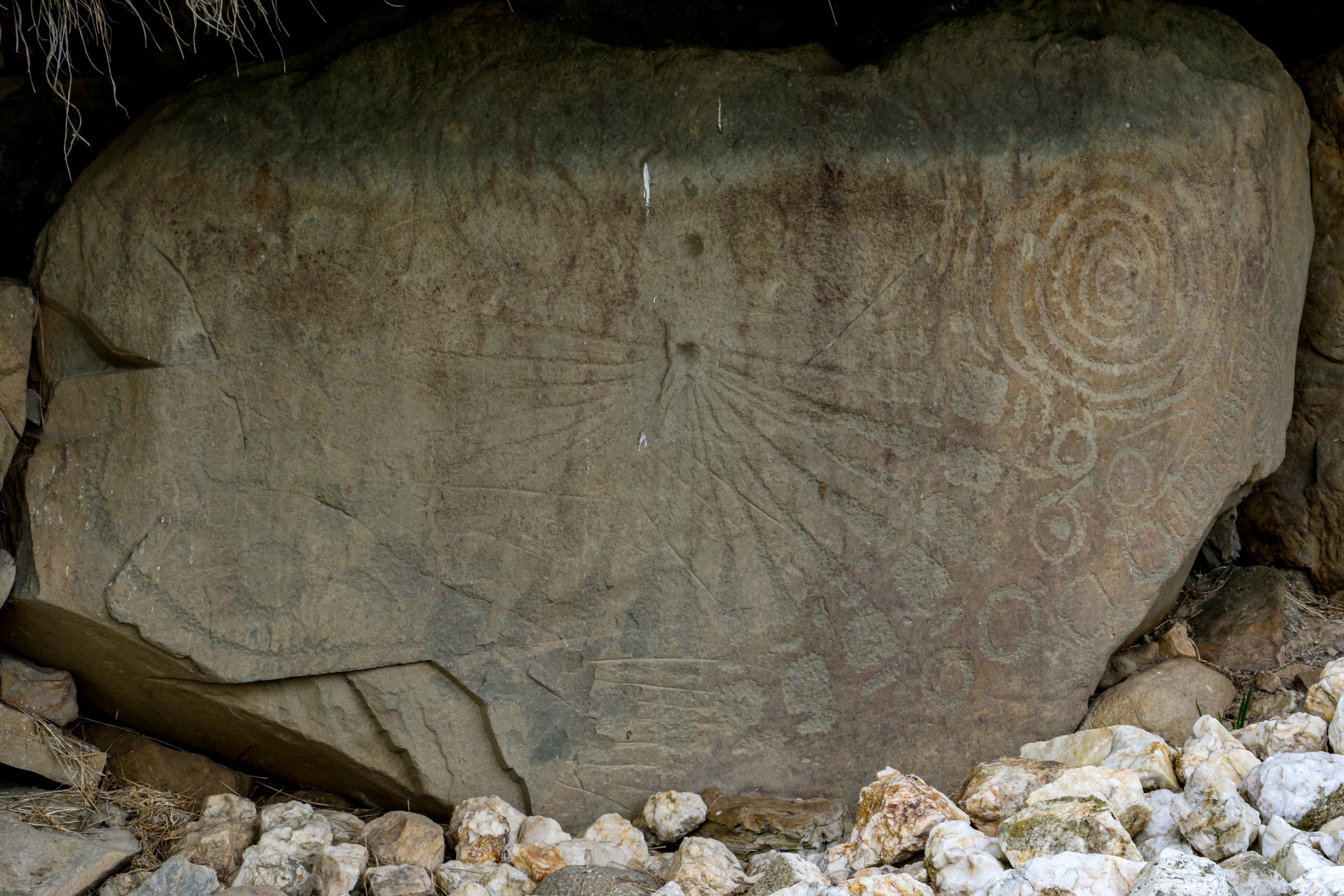 A kerbstone engraved with solar and lunar symbols at the Knowth megalithic tomb in Ireland