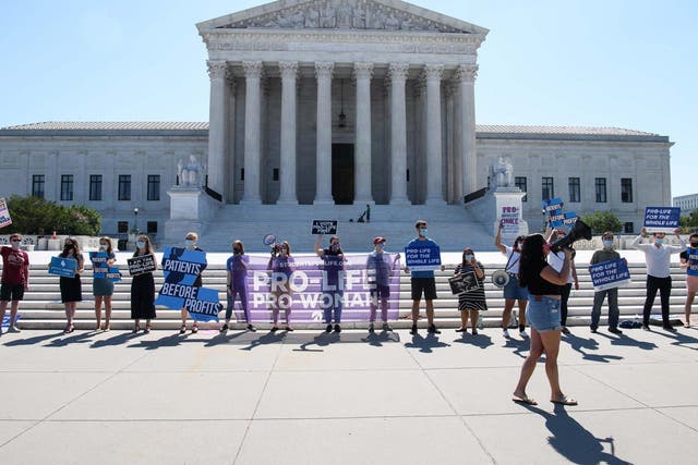 The Supreme Court blocked a Louisiana law that would require doctors to have admitting privileges at local hospitals. Advocates for the law gathered outside the Supreme Court on Monday (pictured)