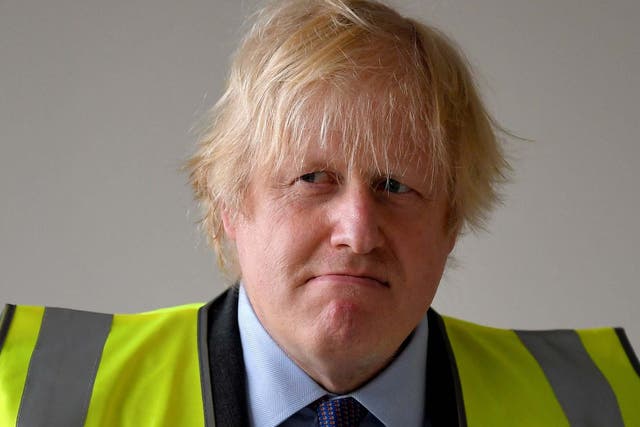 Johnson visits a science room under construction at Ealing Fields High School in west London on Monday
