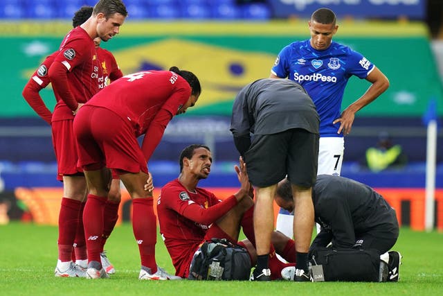Liverpool's Joel Matip receives treatment before being substituted with an injury