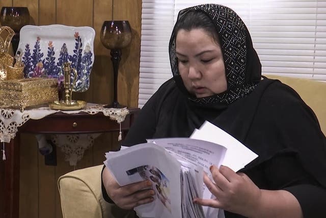 Zumret Dawut, a Uighur from China's far western Xinjiang region, holds documents. Dawut says in China, she was forcibly sterilized for having a third child after being released from a detention camp