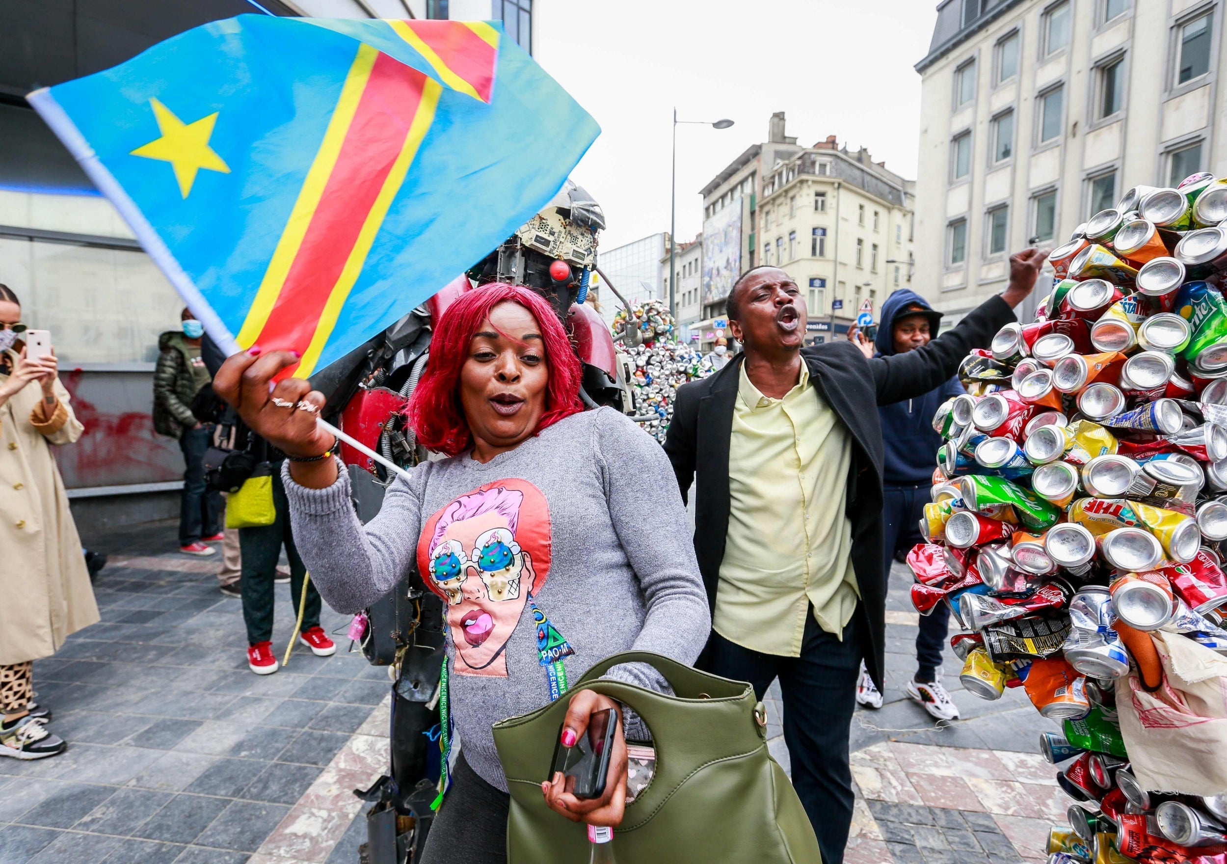 A woman holds a DRC flag as independence day is celebrated in Brussels