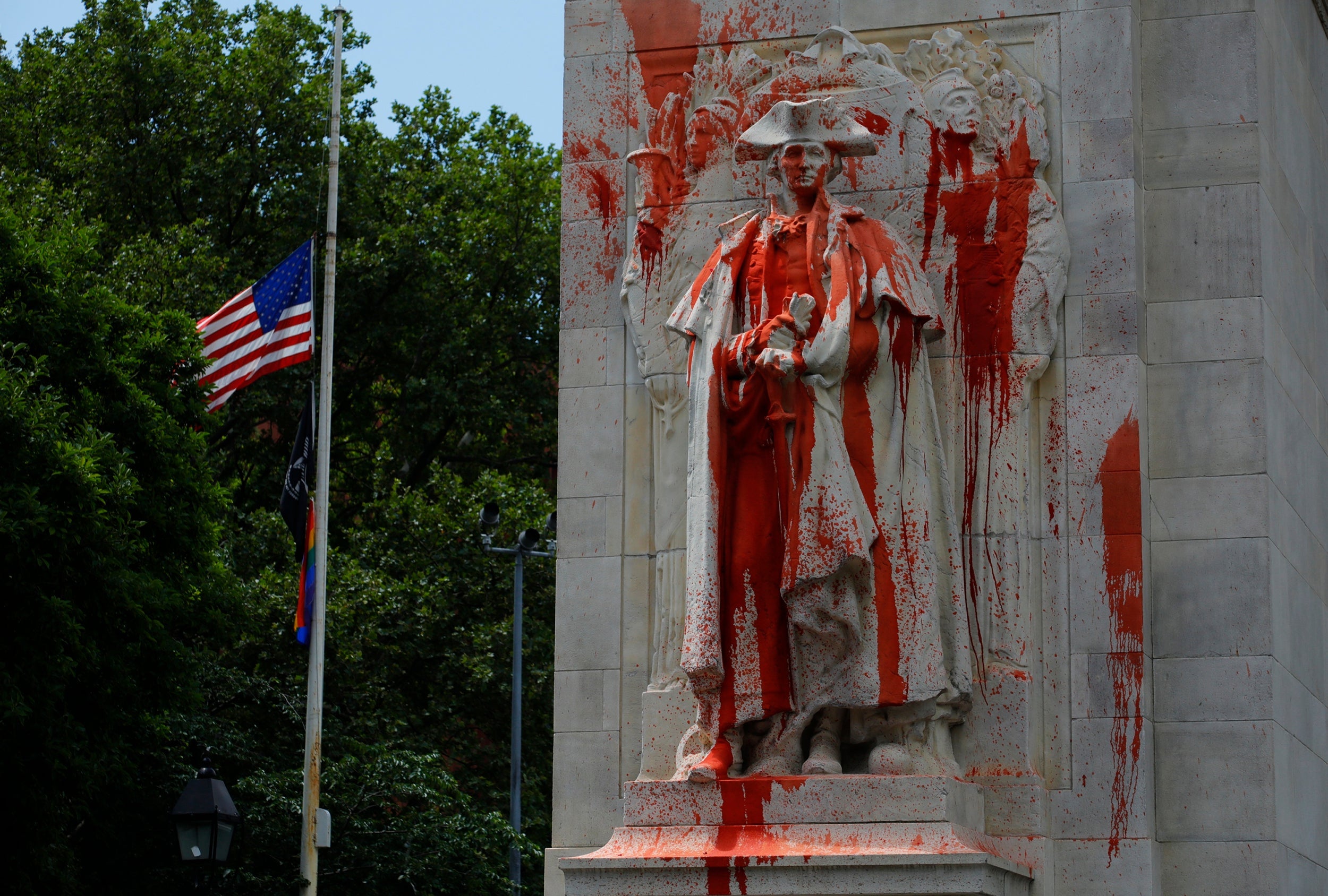 A statue of former US President George Washington is covered in red paint after being vandalised in Washington Square Park in New York