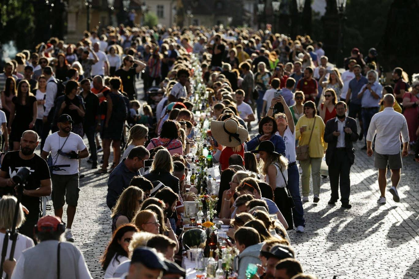 Residents dine at a 500-metre-long table spanning across the length of the medieval Charles Bridge in Prague