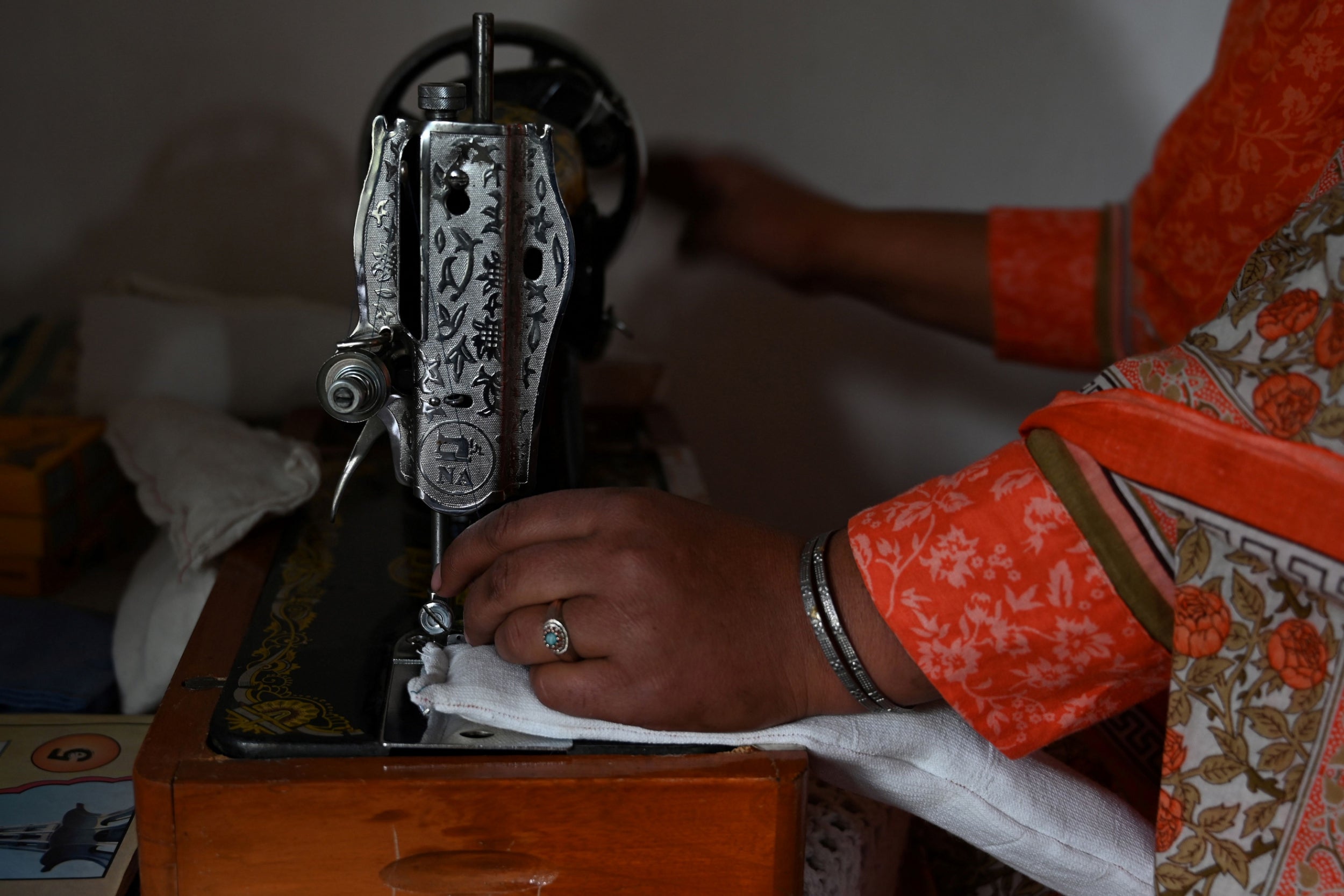 Pakistani woman Hajra Bibi makes a sanitary pad with a sewing machine at home (AFP/Getty)