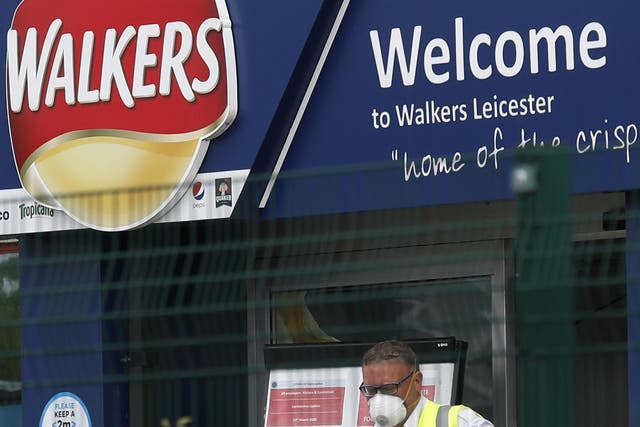 A man exits the Walkers Crisps factory that has confirmed cases of coronavirus amongst its workers in Leicester