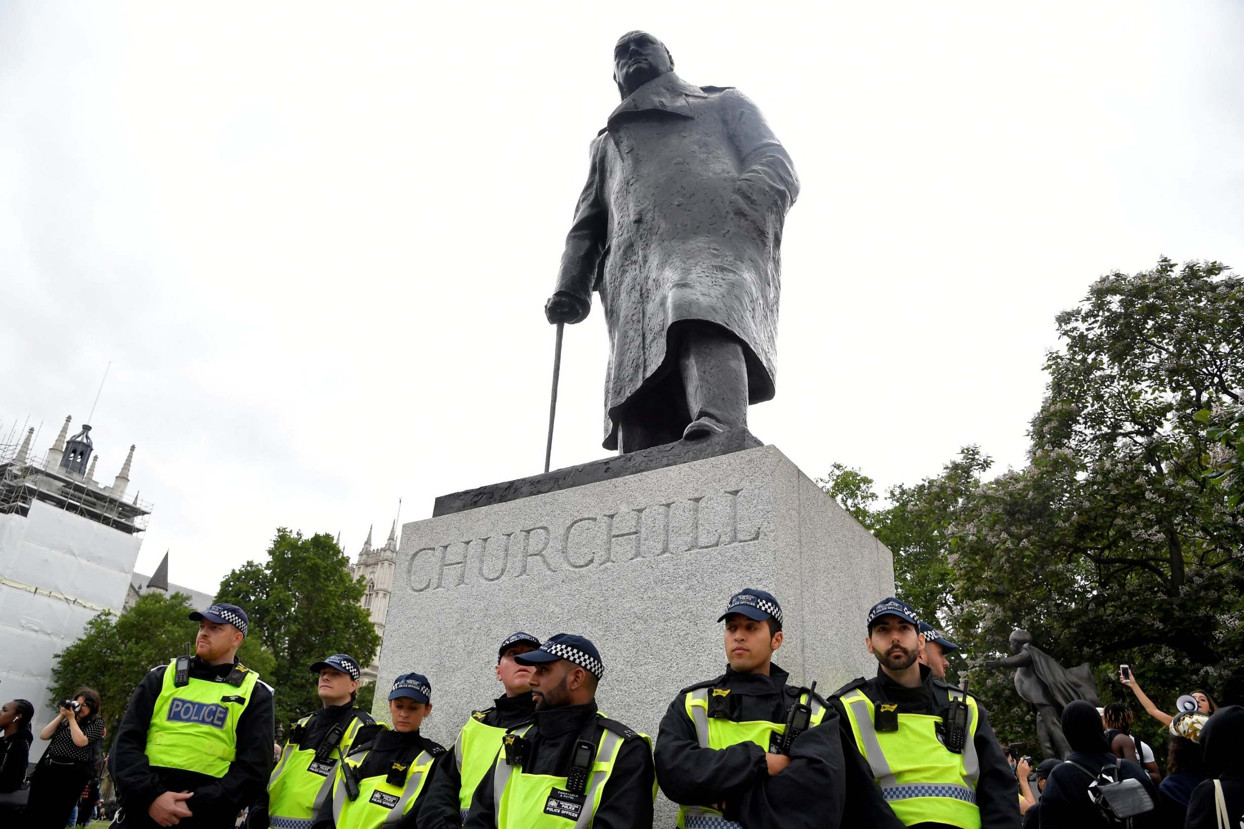 Police officers guard a statue of Winston Churchill during a rally in London