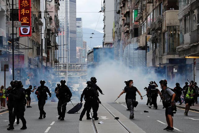 Riot police fire tear gas to disperse anti-national security law protesters on Wednesday