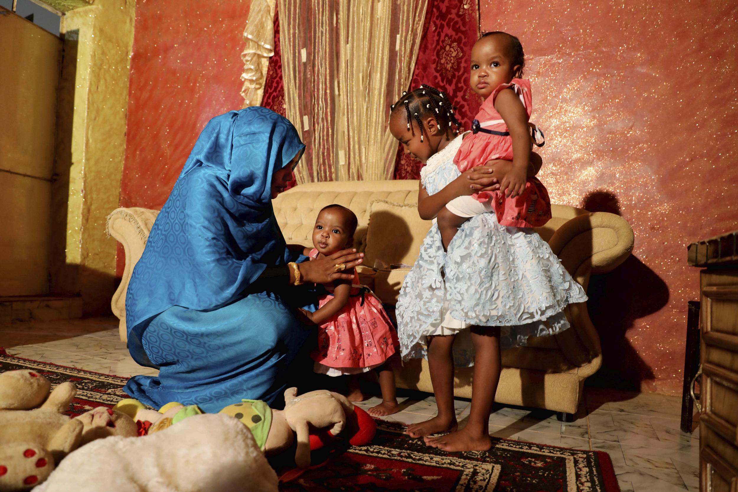 Youssria Awad plays with her daughters in their home, in Khartoum, Sudan. She refuses to carry out female genital mutilation on them, a practice that involves partial or total removal of the external female genitalia for non-medical reasons
