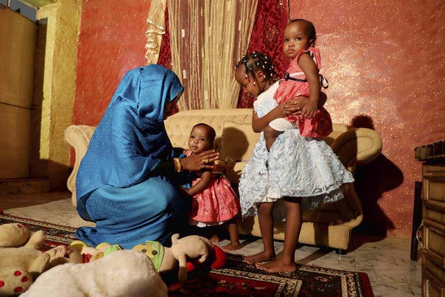 Youssria Awad plays with her daughters in their home, in Khartoum, Sudan. She refuses to carry out female genital mutilation on them, a practice that involves partial or total removal of the external female genitalia for non-medical reasons