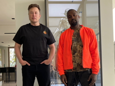 Kanye West and Elon Musk pose in matching orange outfits