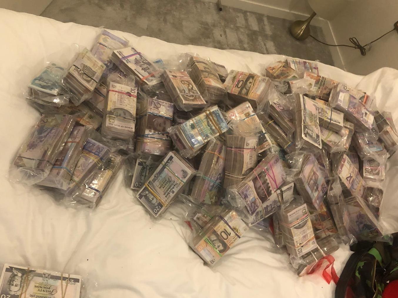 A quantity of cash seized by officers under Operation Venetic in London